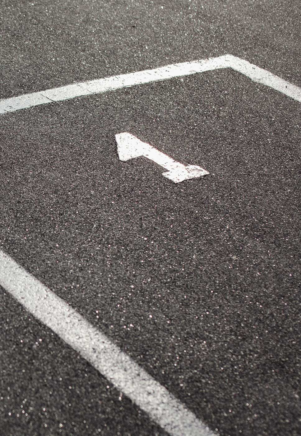 Estrada alcatroada, pintada com umas linhas brancas e o número 1