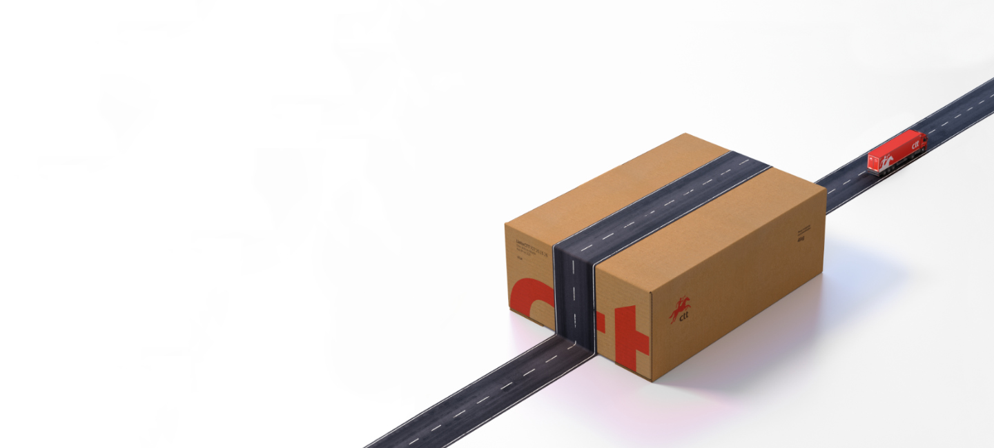 Caixa com estrada pintada e camião de vermelho a sugerir movimento e entrega.